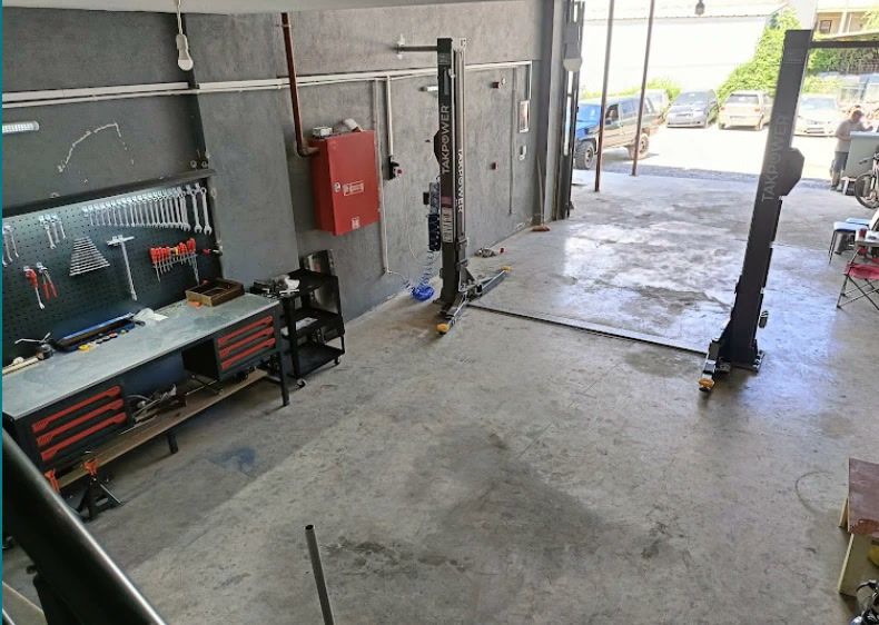 Atölyenin içi: iki sütunlu lift, takım panosu ve çalışma tezgâhı